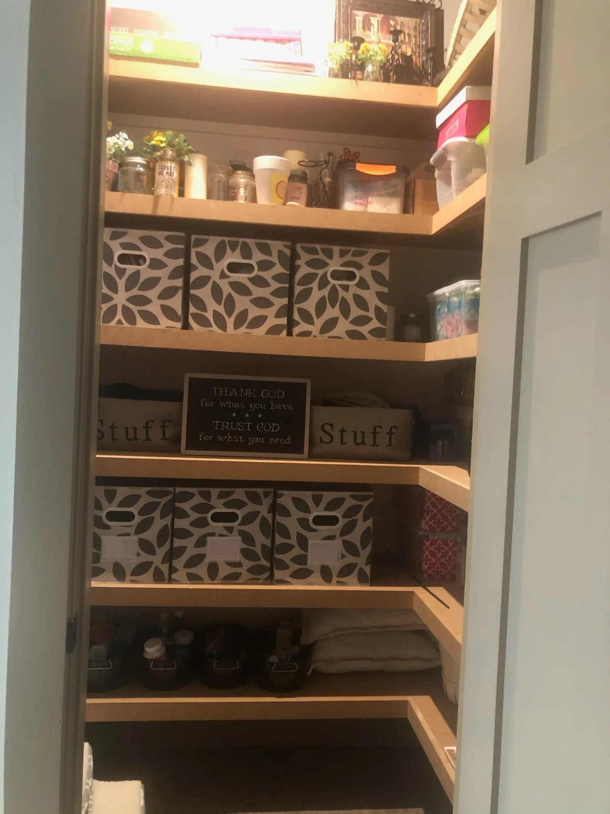 Closet shelves organized with matching storage bins by Spotless Cleaning Services in Monroe, NC