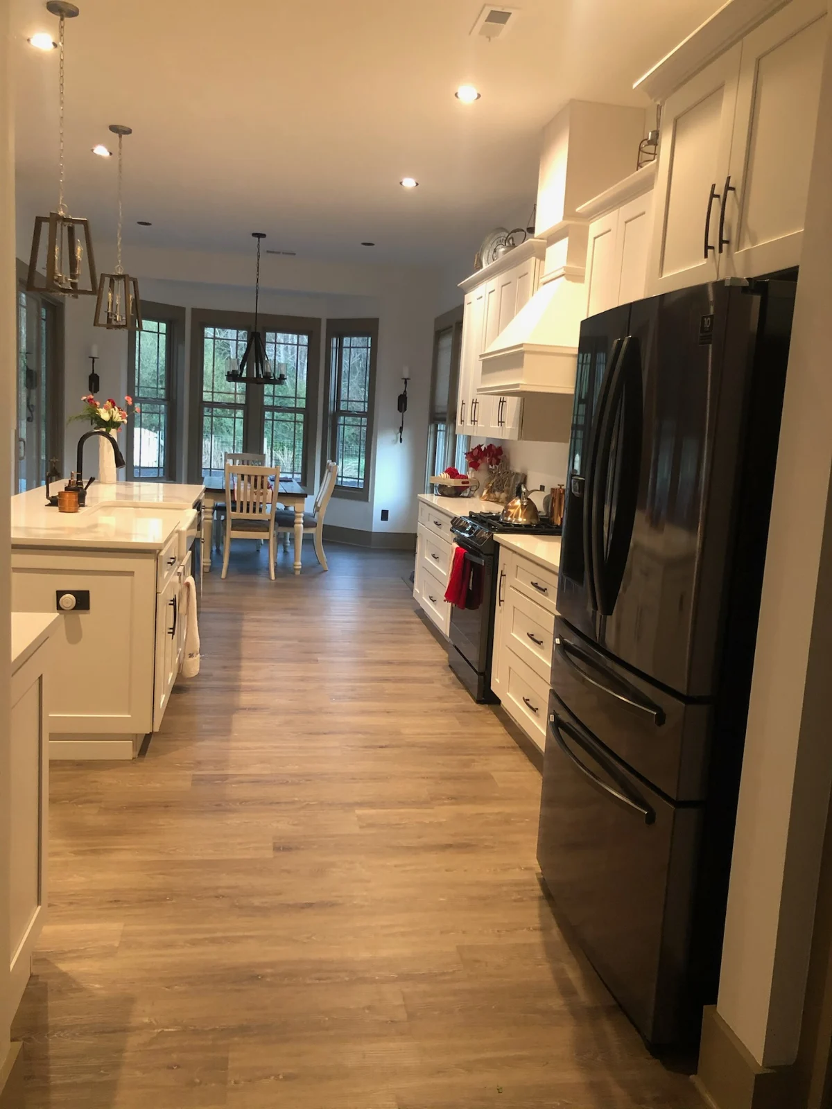 Clean white kitchen with wiped counters and appliances by Spotless Cleaning Services