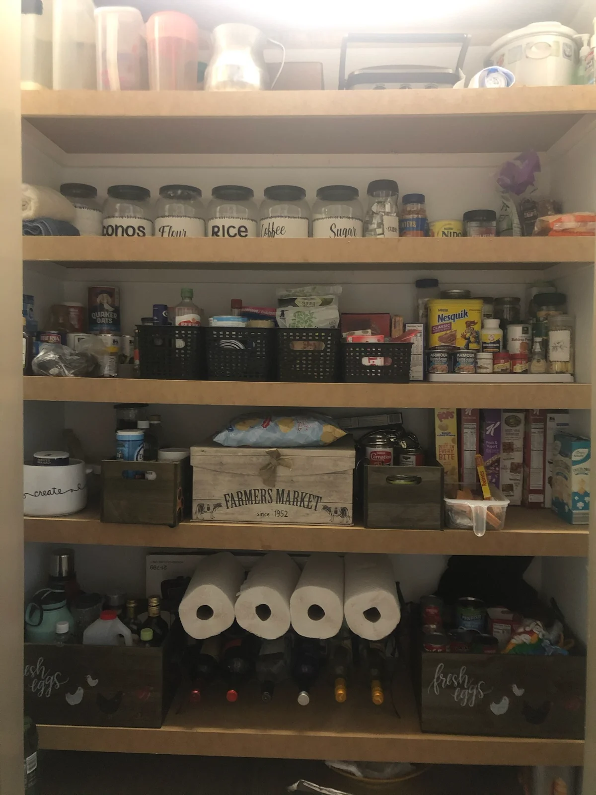 Organized kitchen pantry with labeled jars and baskets by Spotless Cleaning Services in Monroe, NC