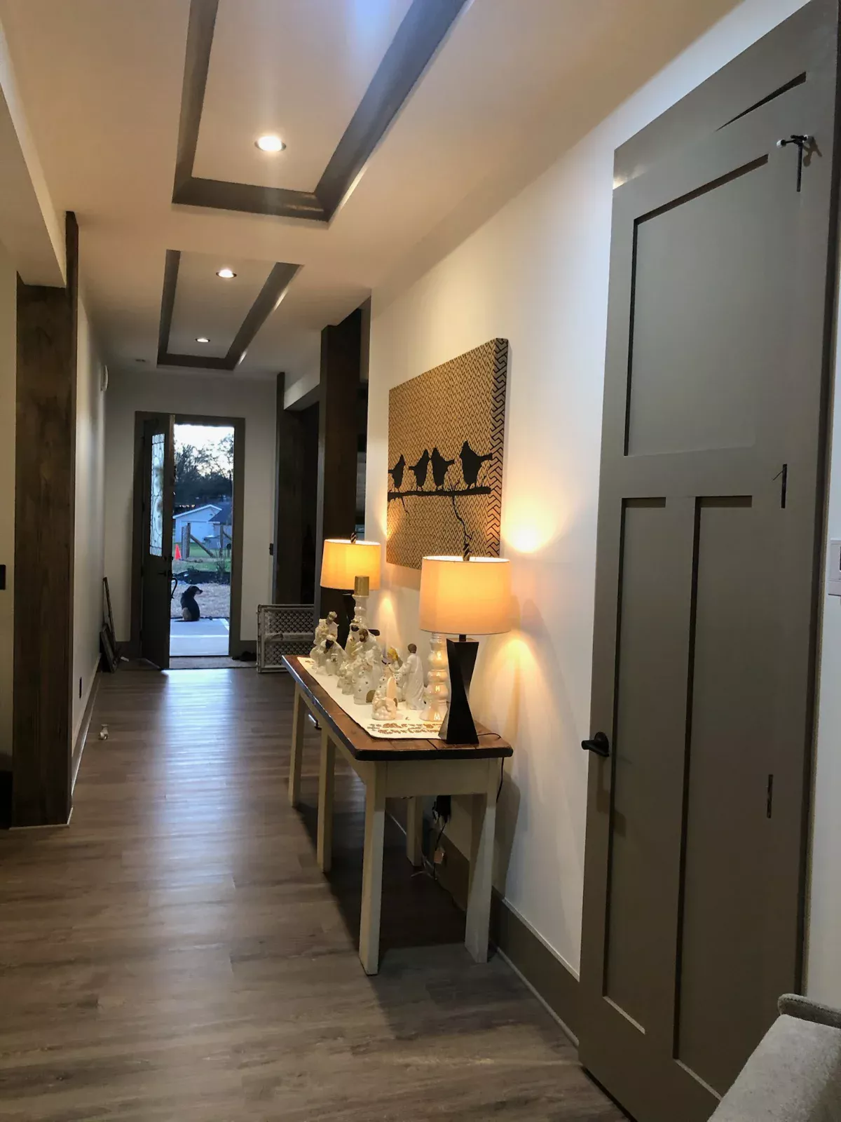 Clean, warmly lit hallway with spotless wood floors in a home cleaned by Spotless Cleaning Services in Monroe, NC